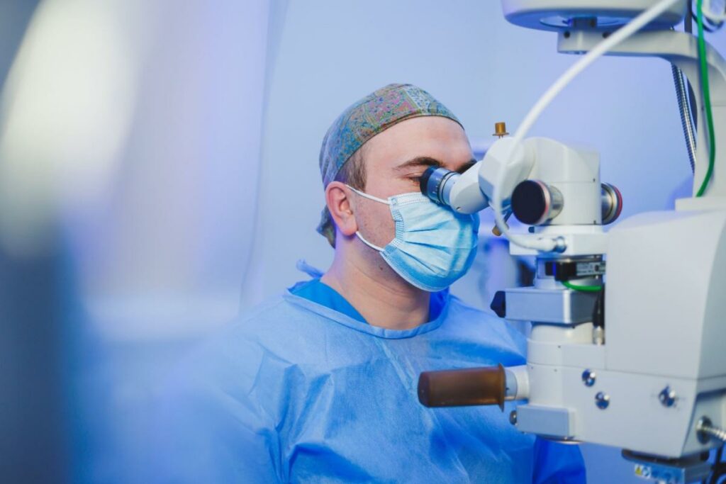 Eye surgeon using a surgical microscope during a laser eye surgery procedure